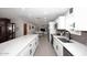 Open kitchen with white cabinets, stainless steel appliances, island and adjoining dining area at 3202 W Joan De Arc W Ave, Phoenix, AZ 85029