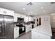 Well-lit kitchen with stainless steel appliances, white cabinets, and a laundry area at 3202 W Joan De Arc W Ave, Phoenix, AZ 85029