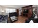 Spacious living room with hardwood floors, a large built-in entertainment center, and modern furnishings at 3202 W Joan De Arc W Ave, Phoenix, AZ 85029