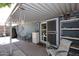 Covered patio with shelving, dining table, and comfortable seating area at 3202 W Joan De Arc W Ave, Phoenix, AZ 85029