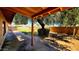 Shady backyard patio area with mature tree cover and wood fencing at 3708 W Peoria Ave, Phoenix, AZ 85029