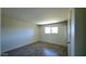 Cozy bedroom with wood-look tile floors and bright natural light from window at 3708 W Peoria Ave, Phoenix, AZ 85029