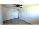 Neutral bedroom with ceiling fan, wood-look floors, and closet doors at 3708 W Peoria Ave, Phoenix, AZ 85029