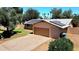 Aerial view of a home's exterior featuring a driveway and installed solar panels at 3708 W Peoria Ave, Phoenix, AZ 85029