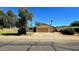 Charming single-story home with a large driveway, front lawn, and a lovely tree, offering great curb appeal at 3708 W Peoria Ave, Phoenix, AZ 85029