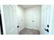 A simple laundry room features white walls, wood-look flooring, and hookups at 3708 W Peoria Ave, Phoenix, AZ 85029
