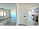 Bright, open-concept living room with wood-look tile flooring and view of kitchen at 3708 W Peoria Ave, Phoenix, AZ 85029