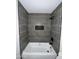 Bathroom featuring updated shower and tub combo with dark fixtures at 3725 E Karen Dr, Phoenix, AZ 85032