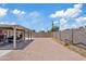 Large backyard with brick-paver ground cover, a covered patio, and block-wall fencing at 4026 W Berridge W Ln, Phoenix, AZ 85019