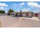 Full backyard view showcasing brick pavers, a covered patio, and access to the home's exterior at 4026 W Berridge W Ln, Phoenix, AZ 85019