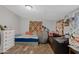 Functional bedroom with wood-look floors, large pillows, and an adjacent sitting area at 4026 W Berridge W Ln, Phoenix, AZ 85019