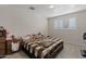 Bedroom with a window and a bed with a brown and white checkered blanket at 4026 W Berridge W Ln, Phoenix, AZ 85019