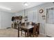 Cozy dining area with wood table, shelving, and shuttered window, offering a warm and inviting space at 4026 W Berridge W Ln, Phoenix, AZ 85019