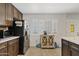 Modern kitchen features stainless steel refrigerator, custom wood cabinetry and bright natural light from the window at 4026 W Berridge W Ln, Phoenix, AZ 85019