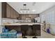 Stylish kitchen with dark wood cabinets, island seating, and stainless steel appliances for modern living at 4026 W Berridge W Ln, Phoenix, AZ 85019