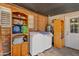 Practical laundry area with ample storage shelves, a washing machine, and utility access at 4026 W Berridge W Ln, Phoenix, AZ 85019