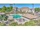 A community pool and surrounding lounge furniture are surrounded by mature trees and lush landscaping at 4169 E Jasper Dr, Gilbert, AZ 85296
