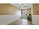 Well-lit home office space with tile flooring, white wainscotting, and a ceiling fan at 4169 E Jasper Dr, Gilbert, AZ 85296
