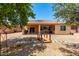 Desert landscaped backyard featuring a covered patio, wooden bridge and low maintenance at 42709 W King Fisher Dr, Maricopa, AZ 85138
