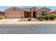 Charming single-story home featuring a two-car garage and well-maintained desert landscaping at 42709 W King Fisher Dr, Maricopa, AZ 85138