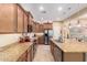 Modern kitchen with granite counters, stainless appliances, and ample cabinet space at 42709 W King Fisher Dr, Maricopa, AZ 85138