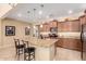 Bright, updated kitchen features stainless appliances and a large center island with barstool seating at 42709 W King Fisher Dr, Maricopa, AZ 85138