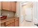 Convenient laundry room with cabinetry and appliances for efficient home management at 42709 W King Fisher Dr, Maricopa, AZ 85138