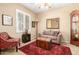 Cozy living room with a comfortable seating arrangement and a vintage-style trunk at 42709 W King Fisher Dr, Maricopa, AZ 85138