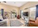Bright living room with comfortable seating, backyard access and a TV entertainment center at 42709 W King Fisher Dr, Maricopa, AZ 85138