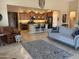 Spacious living room with open floor plan leading into a modern kitchen at 42709 W King Fisher Dr, Maricopa, AZ 85138