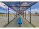 Enclosed walkway to community tennis courts featuring benches and full fencing for shade and privacy at 42709 W King Fisher Dr, Maricopa, AZ 85138