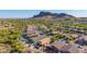 Aerial view of homes with private pools nestled in desert landscape with mountains in the background at 4297 S Pony Rider Trl, Gold Canyon, AZ 85118