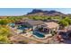 Scenic aerial view of a home with a pool, cabana, and mountain backdrop in a desert community at 4297 S Pony Rider Trl, Gold Canyon, AZ 85118