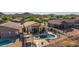 Aerial perspective of a backyard with a pool, spa, cabana and covered patio in a residential area at 4297 S Pony Rider Trl, Gold Canyon, AZ 85118
