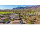 Scenic aerial view capturing lush desert homes, natural vegetation, and impressive mountain vistas at 4297 S Pony Rider Trl, Gold Canyon, AZ 85118