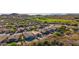 Stunning aerial view of a desert community with lush golf course, mountain views, and private pools at 4297 S Pony Rider Trl, Gold Canyon, AZ 85118