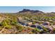 Expansive aerial showcasing desert homes surrounded by lush green landscaping and scenic mountain views at 4297 S Pony Rider Trl, Gold Canyon, AZ 85118