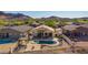 Overhead view of a home with a pool, cabana, and covered patio in a peaceful neighborhood setting at 4297 S Pony Rider Trl, Gold Canyon, AZ 85118