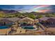 Inviting backyard with a sparkling pool, spa, and covered patio, perfect for outdoor relaxation and entertaining at 4297 S Pony Rider Trl, Gold Canyon, AZ 85118
