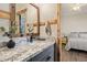 Bathroom with granite countertops, wood framed mirror, and view into bedroom at 4297 S Pony Rider Trl, Gold Canyon, AZ 85118