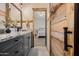 Bathroom with granite countertops, barn door, and view into bedroom at 4297 S Pony Rider Trl, Gold Canyon, AZ 85118