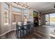 Bright dining room with ample natural light, dark wood table, and a view of the home office and outdoor patio at 4297 S Pony Rider Trl, Gold Canyon, AZ 85118