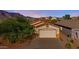 Exterior elevation of a single Gathering home with a 2-car garage and desert landscaping at 4297 S Pony Rider Trl, Gold Canyon, AZ 85118