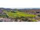 Aerial of a well-manicured golf course surrounded by lush desert homes and mountain views at 4297 S Pony Rider Trl, Gold Canyon, AZ 85118