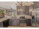 Well-equipped kitchen featuring stainless steel appliances, granite countertops, dark wood cabinets, and a view of the living area at 4297 S Pony Rider Trl, Gold Canyon, AZ 85118