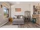 Comfortable living room with gray sofa, rustic wood bar, and window view, perfect for relaxing and entertaining guests at 4297 S Pony Rider Trl, Gold Canyon, AZ 85118
