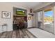 Stylish home office with a custom desk, TV, and sliding door to backyard at 4297 S Pony Rider Trl, Gold Canyon, AZ 85118