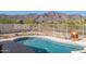 Inviting pool with stunning mountain views and white fencing at 4297 S Pony Rider Trl, Gold Canyon, AZ 85118