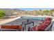 Relaxing patio with a pool, lounge chairs, and mountain views at 4297 S Pony Rider Trl, Gold Canyon, AZ 85118