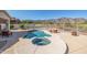 Backyard pool and hot tub with mountain views at 4297 S Pony Rider Trl, Gold Canyon, AZ 85118